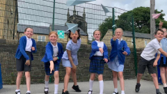 Children in the playground with paper aeroplanes